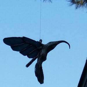 Three-dimensional, metal-bodied stained glass hummingbird